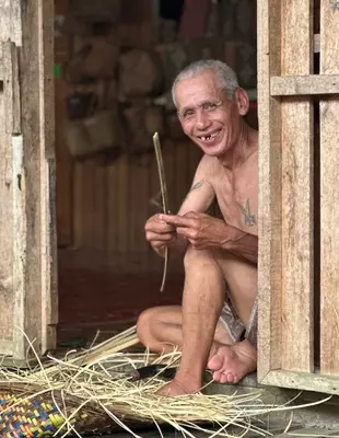 Hymyilevä mies Iban-heimosta Batang Aissa